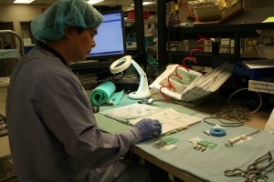 Technician Venice Macaranas assembles a set of instruments for the cardiac department.
